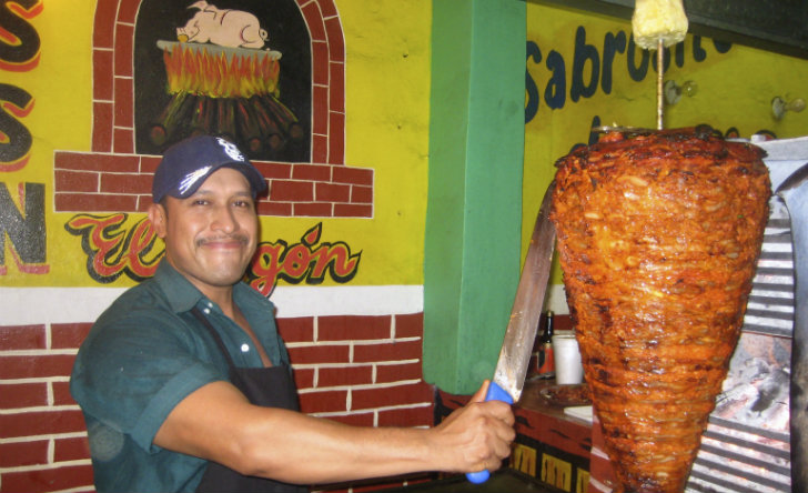Carving the pork for tacos al pastor